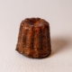 Canelé  A canelé is a small French pastry flavored with rum and vanilla with a soft and tender custard center and a dark, thick caramelized crust.